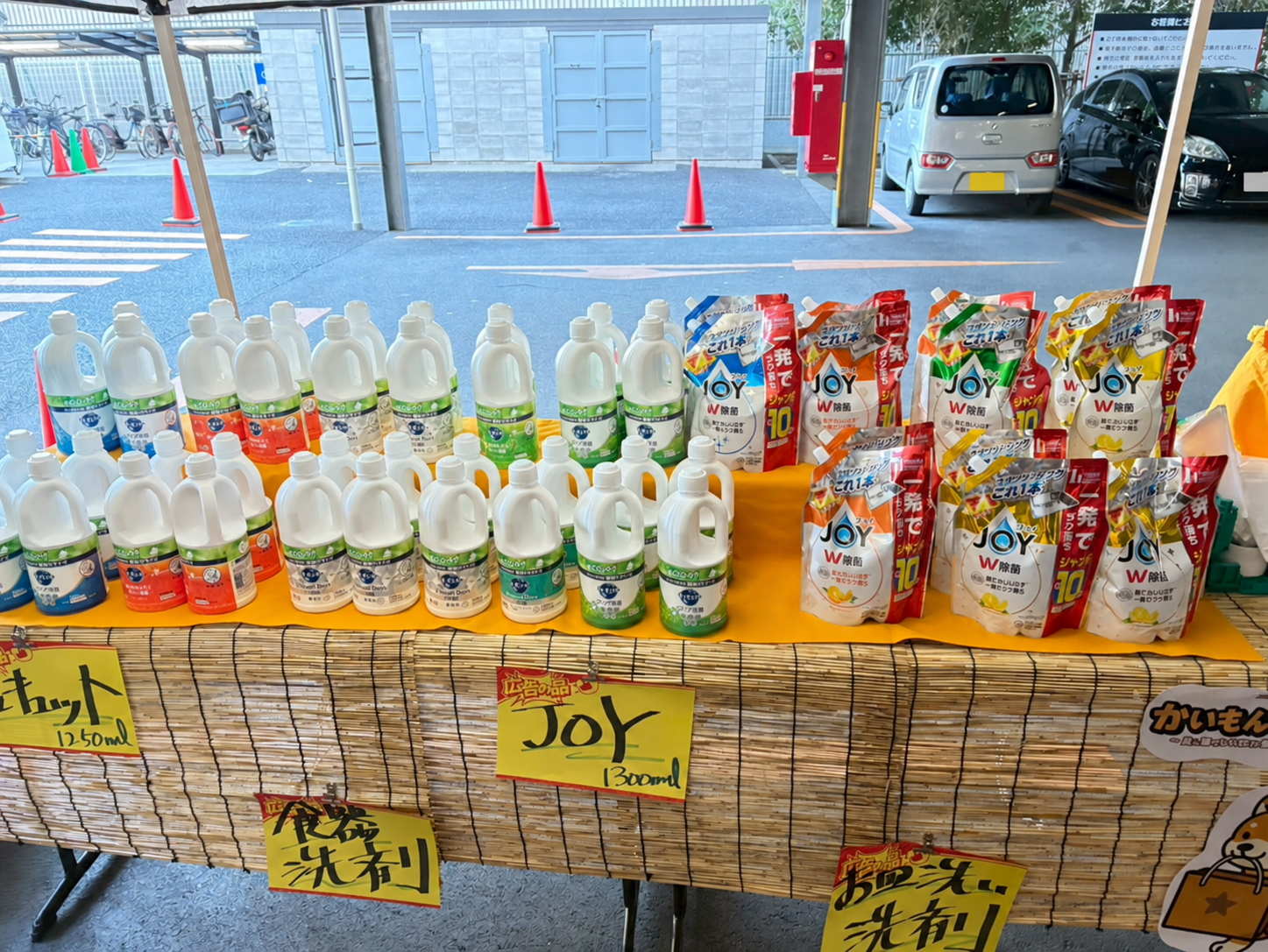 黄色いクロスに並ぶ日用品と手書きのPOP